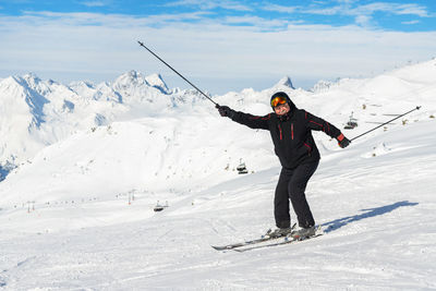 Full length of man skiing on snowcapped mountain