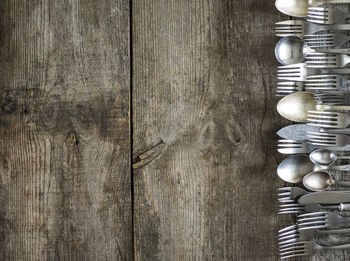 High angle view of old silverware on wooden table