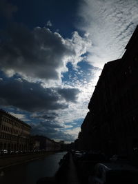Street amidst buildings against sky in city