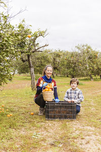 Portrait of a smiling girl sitting on tree