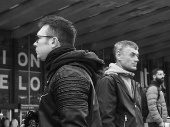 Portrait of young man standing in city