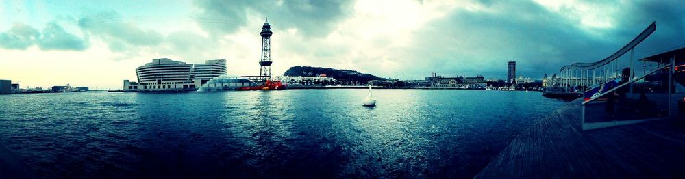 View of harbor against cloudy sky