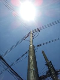 Low angle view of power lines against blue sky