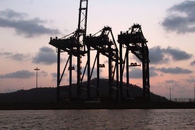 Silhouette built structure against sky at sunset