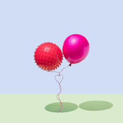 Close-up of red balloons against white background