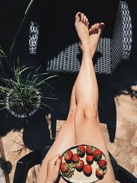 Low section of woman lying on display