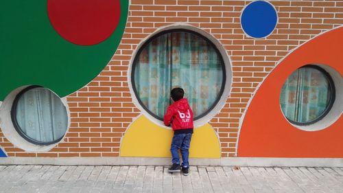 People standing in front of multi colored wall