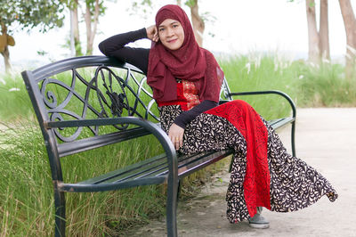 Portrait of young woman sitting on seat