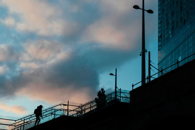 Low angle view of silhouette bridge against sky at sunset