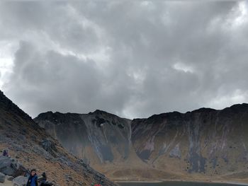 Scenic view of mountains against cloudy sky