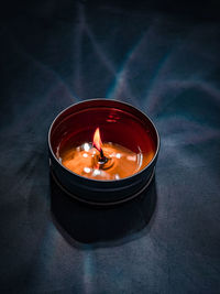 High angle view of lit tea light candles on table