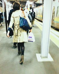 Full length of woman standing by railing