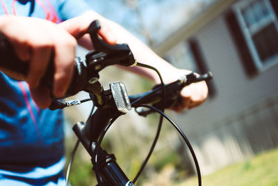 Close-up of person holding bicycle