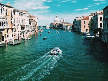 Boats in river with buildings in background