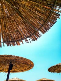 Low angle view of traditional windmill against clear blue sky