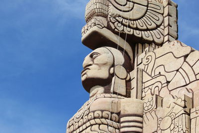 Low angle view of statue against blue sky