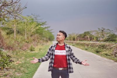 Portrait of young man standing on field