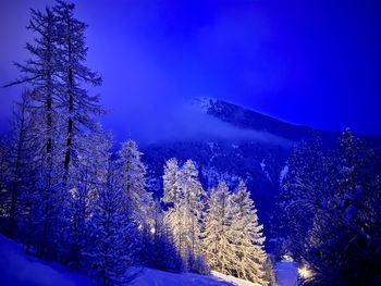 Scenic view of snowcapped mountains against blue sky