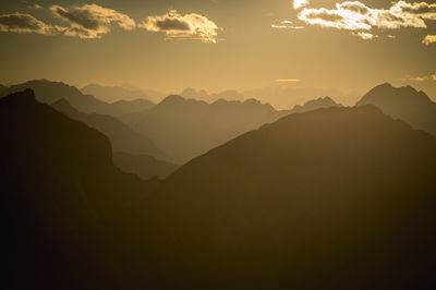 Scenic view of mountains against sky at sunset