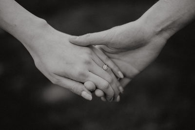 Close-up of couple holding hands