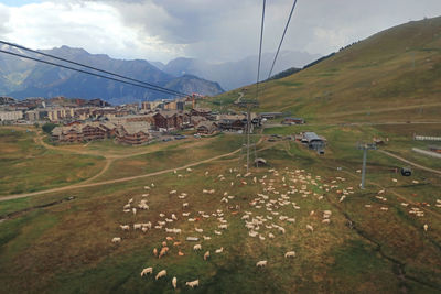 Scenic view of landscape and houses against sky