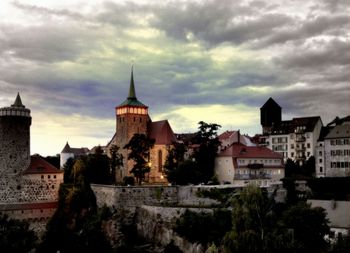 Buildings against cloudy sky