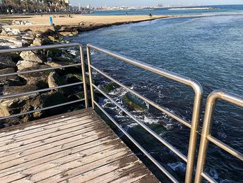 High angle view of railing by sea