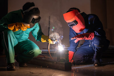 Workers welding metal