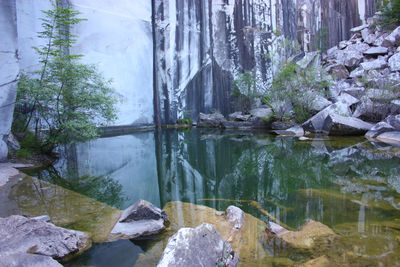 Small natural lake inside a marble quarry in mountain in apuan alps