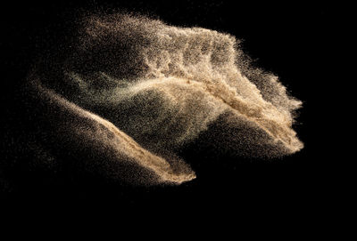 Close-up of water splashing against black background