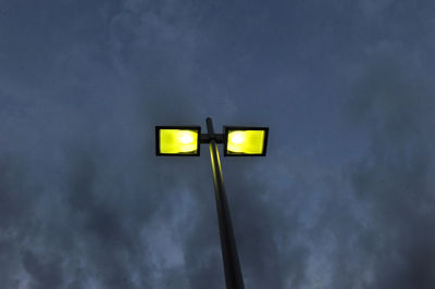 Low angle view of illuminated street light against sky