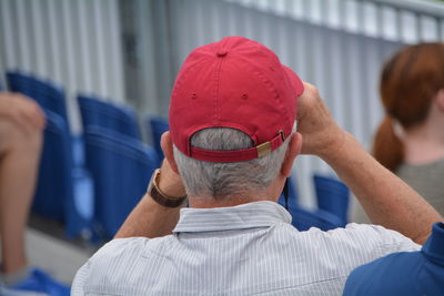 Rear view of man wearing red cap at stadium