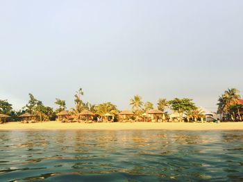 Swimming pool by sea against clear sky