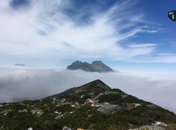 Scenic view of clouds covering rocky mountains