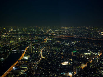 Aerial view of city lit up at night