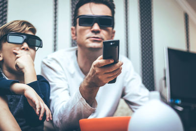 Man looking at camera while sitting in laptop