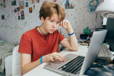 Young woman using laptop on table