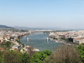 High angle view of river amidst buildings in city against sky