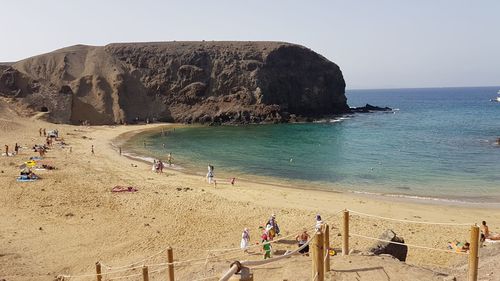 People on beach against sky