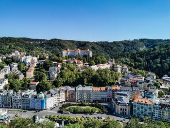 High angle view of townscape against clear blue sky