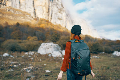 Rear view of man standing on rock