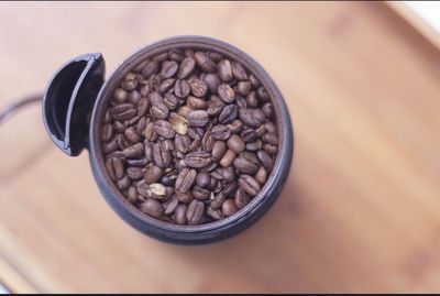 Close-up of coffee beans in container on table