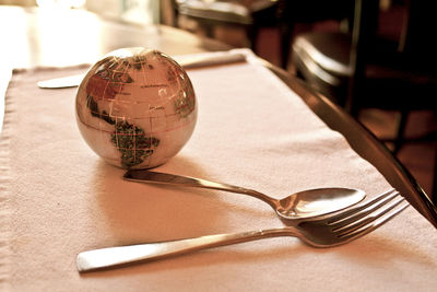 Close-up of disco ball and cutlery on table
