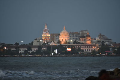 View of city lit up at waterfront