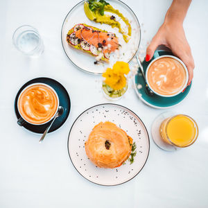 Top view of the unknown woman hand holding avocado toast