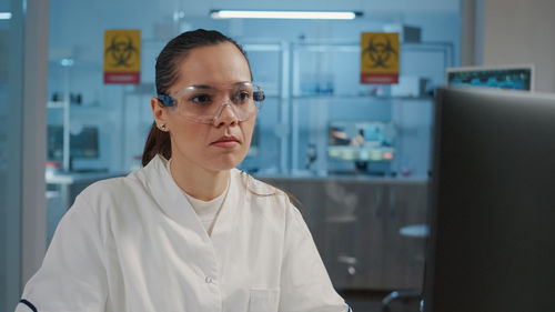 Portrait of young woman standing in office