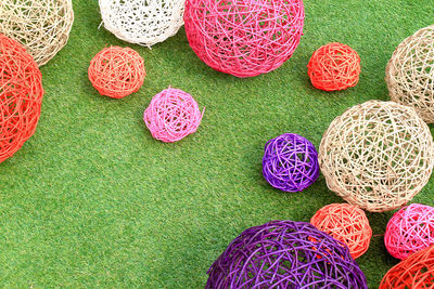 High angle view of colorful straw balls on grass