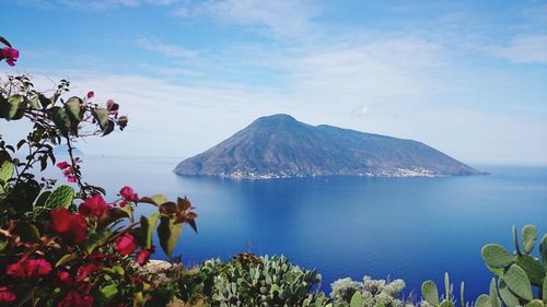 Scenic view of sea and mountains against sky