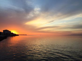 Scenic view of sea against romantic sky at sunset