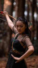 Midsection of woman with arms raised